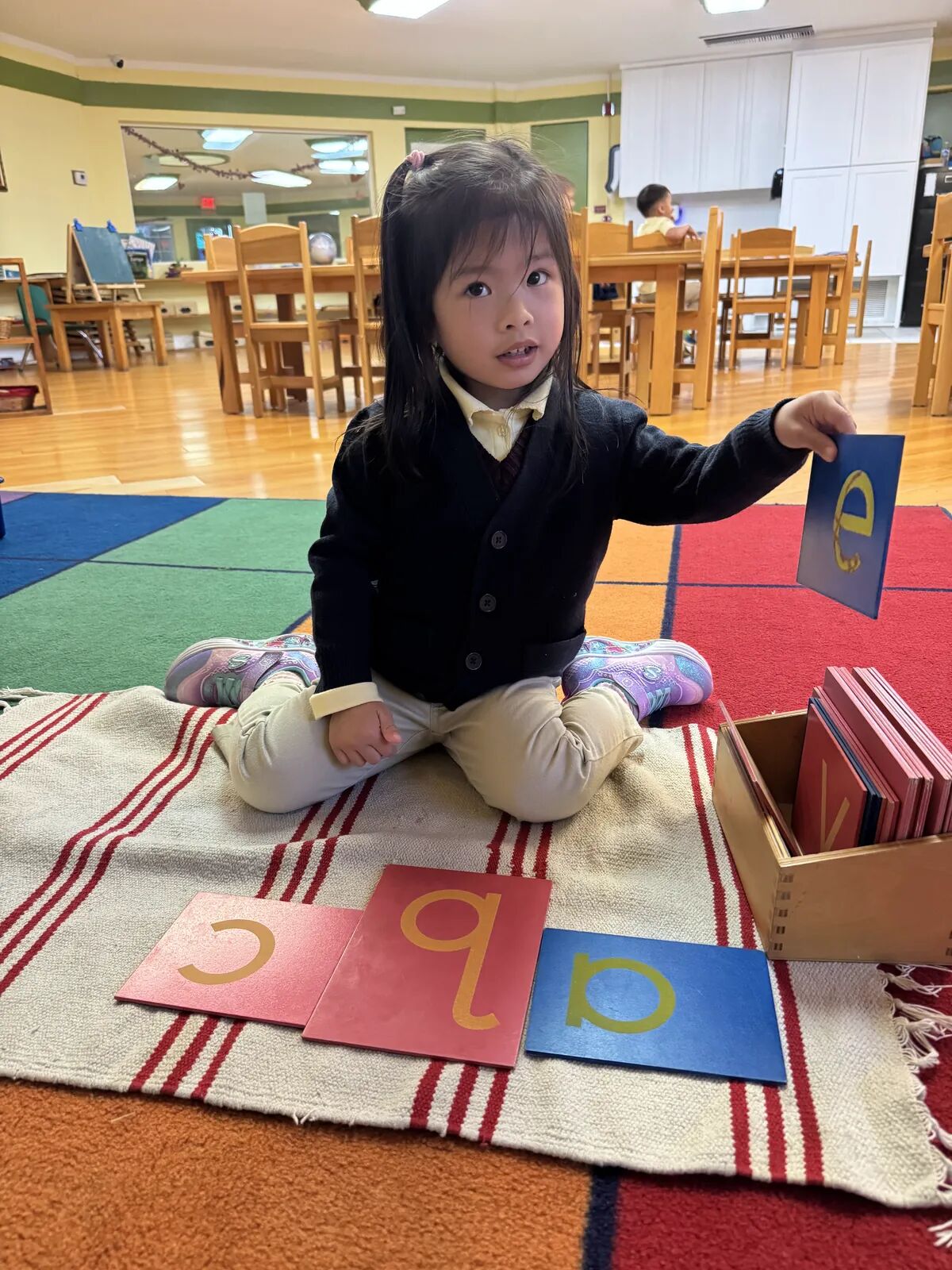 Tracing sandpaper letters – Slater Montessori Academy